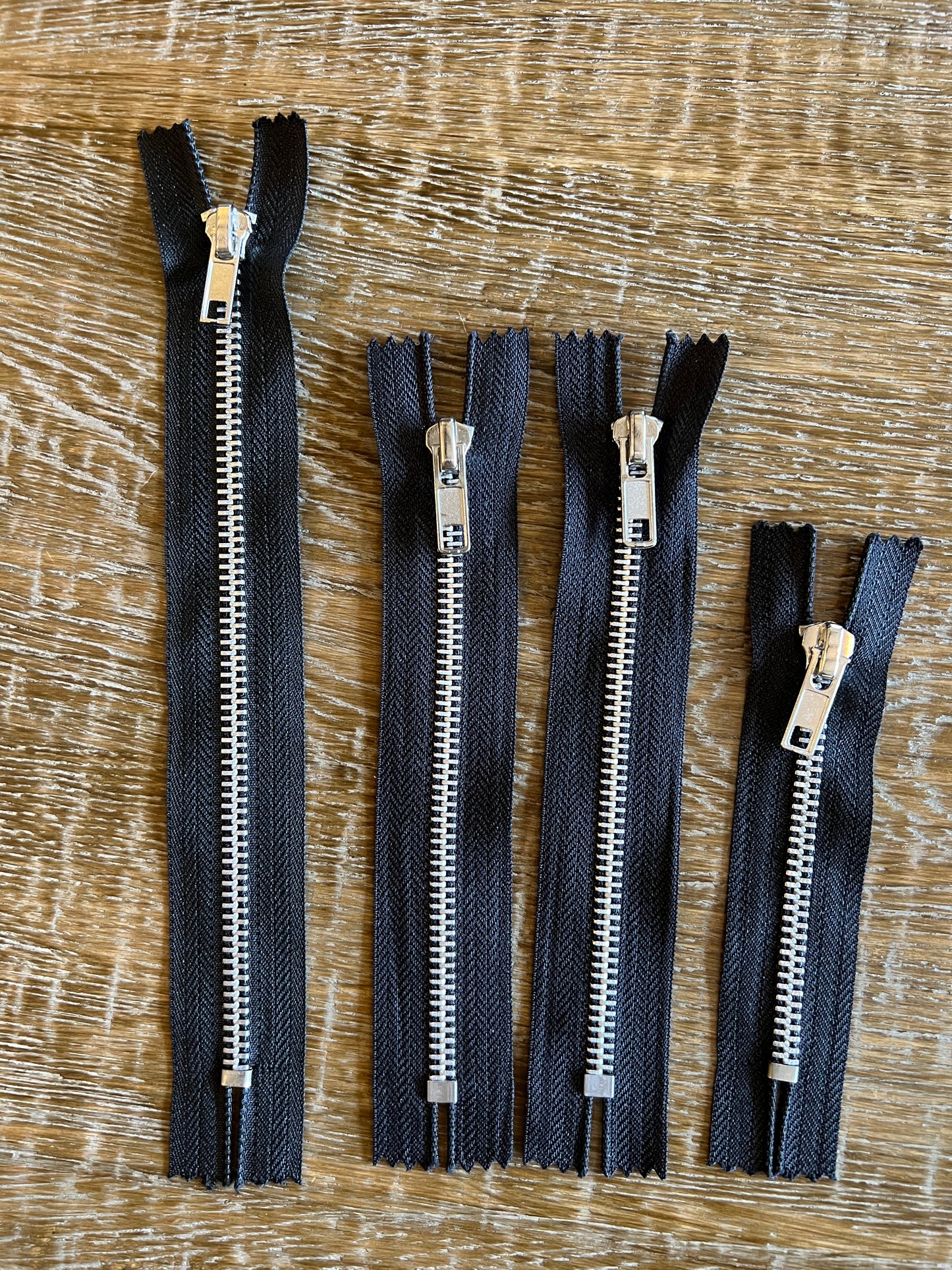Closed End Metal Zippers on Black Tape